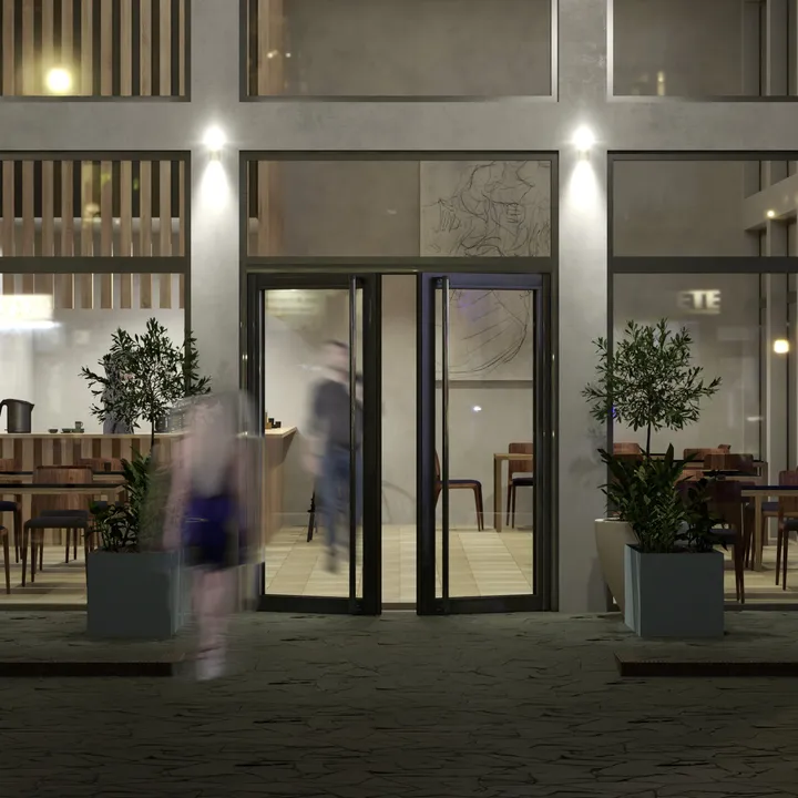 Devanture vitrée d'un bistrot le soir, porte double aluminium noire entre deux vitrines