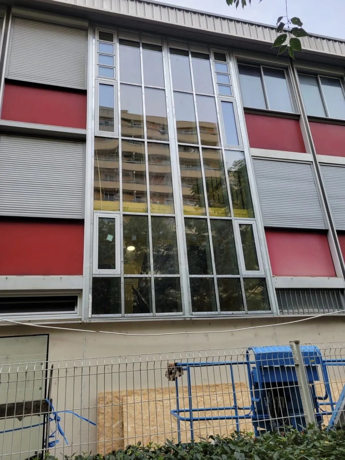 Mur-rideau aluminium en cours de pose, nacelle au pied de la façade