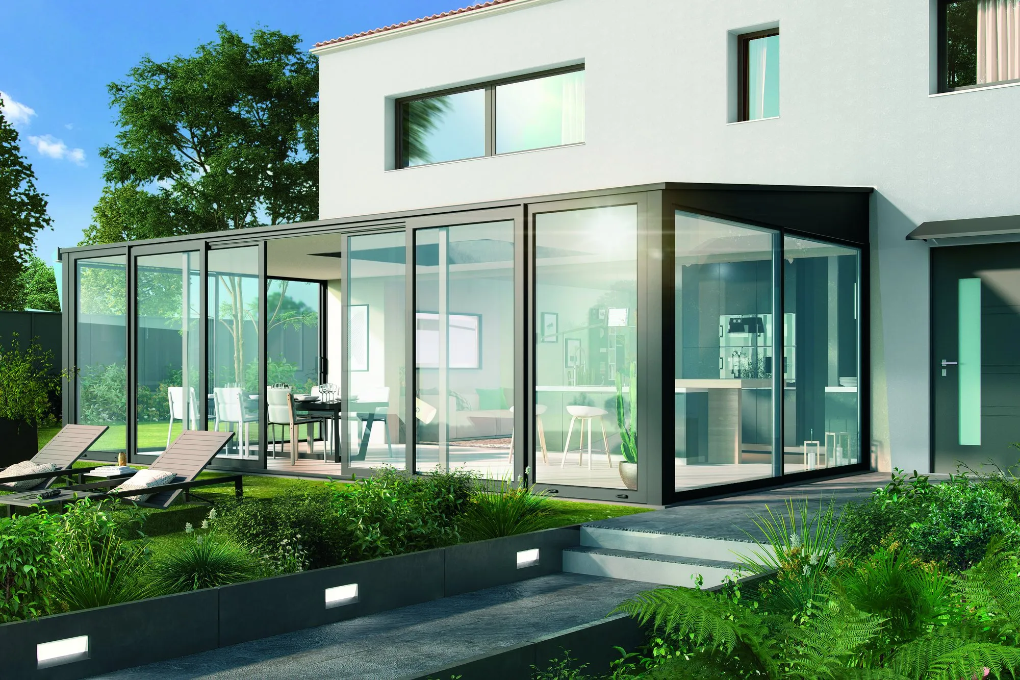 Véranda contemporaine à toiture plate prolongeant une cuisine sur le jardin